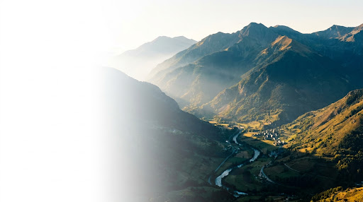 Panoramic view of the Val d'Aran mountain range with mist and morning sunlight